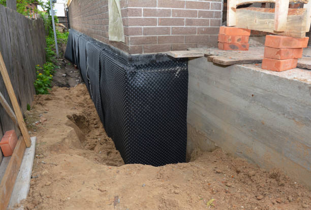 SJ Waterproofing Pros technician performing targeted Wet Basement Repair assessment in New Prague, MN